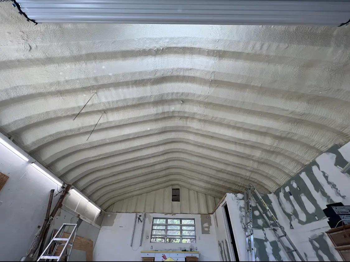 Spray polyurethane foam applied to the underside of a metal roof deck in San Marino
